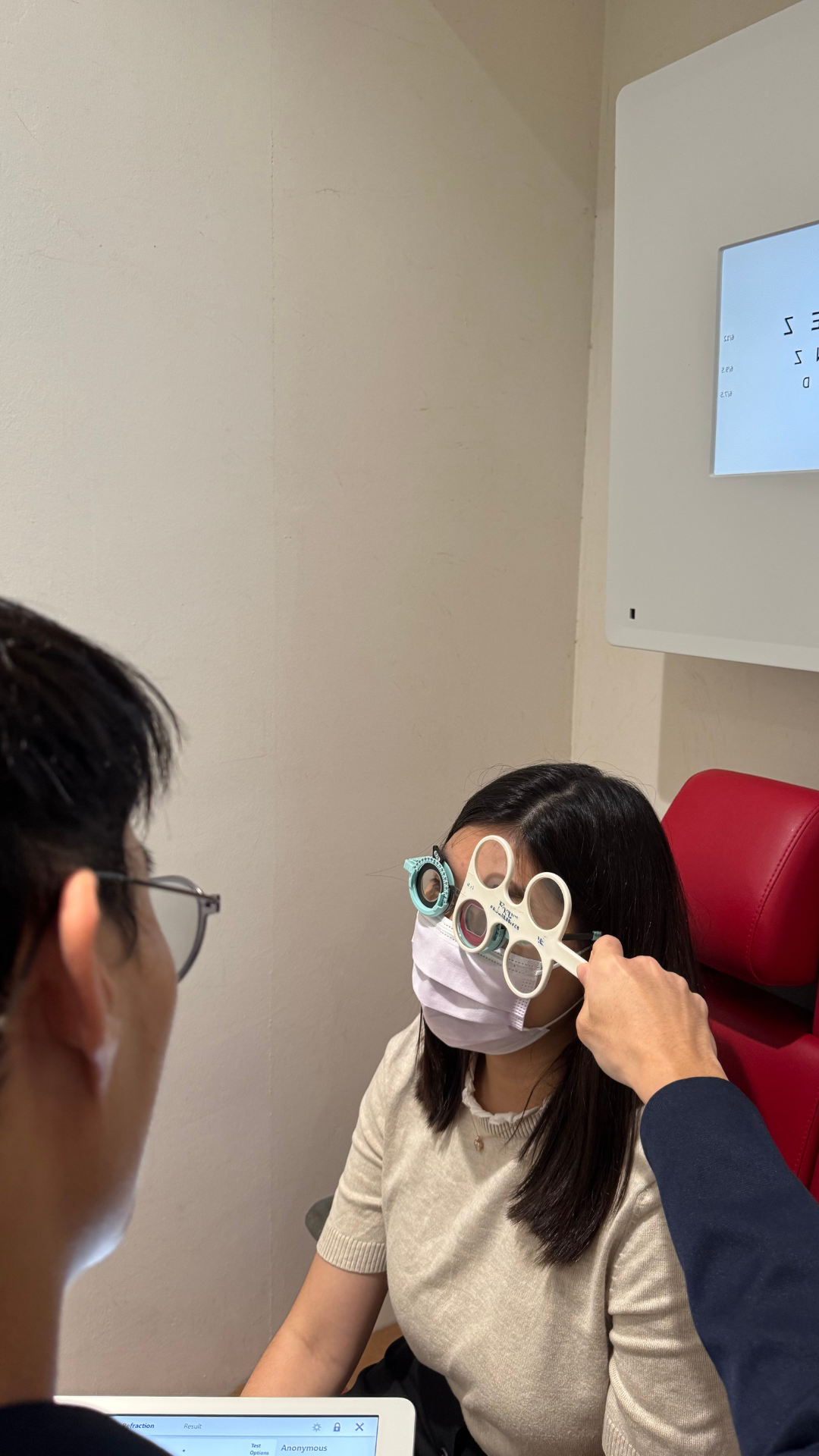 1-KJ-Optometrists-Performing-Prescription-Examination-Eye-Check-For-Myopia