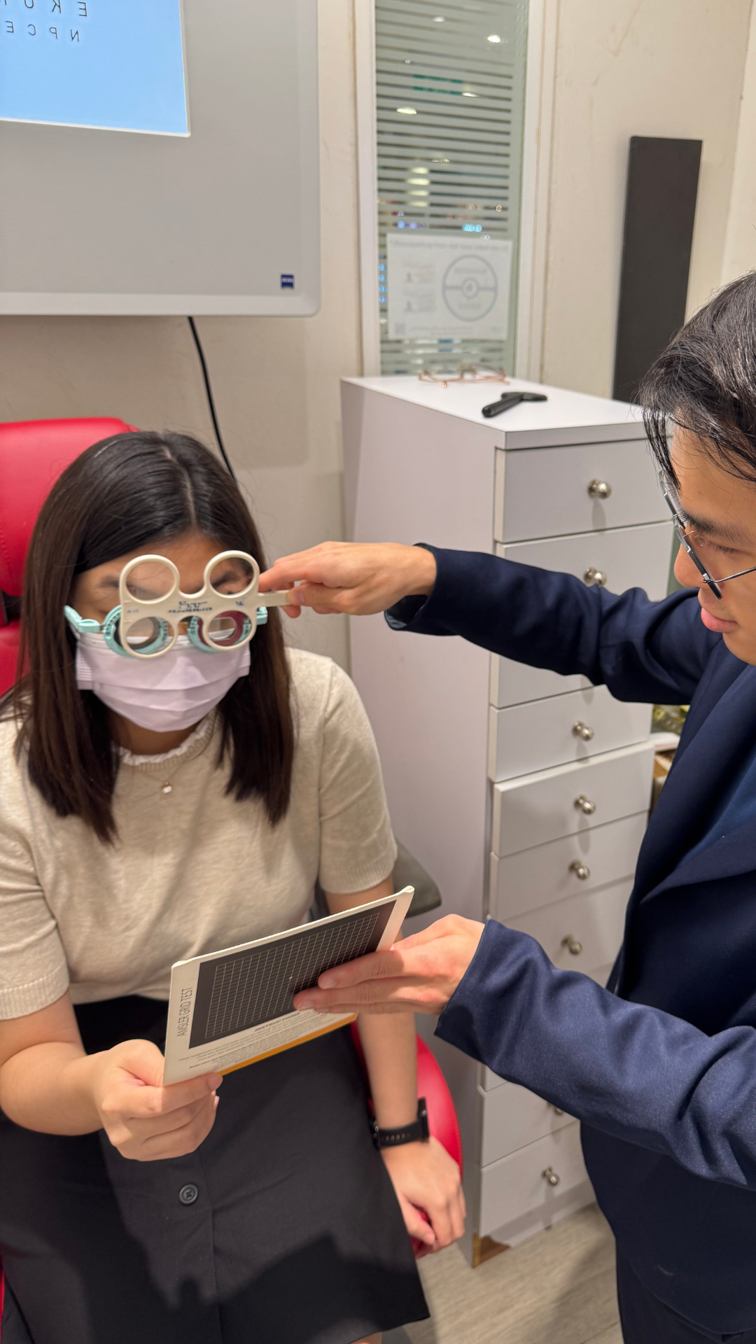 2-KJ-Optometrists-Performing-Prescription-Examination-Eye-Check-For-Presbyopia